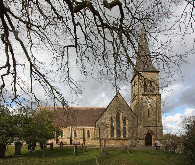 St John the Evangelist church, Hildenborough, framed by bare winter trees.